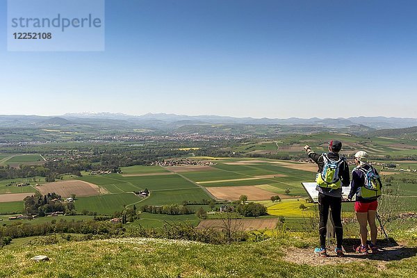 Wanderer genießen den Blick vom Dorf Usson auf die Ebene der Limagne und die Vulkanlandschaft der Chaine des Puys  Departement Puy de Dome  Auvergne  Frankreich  Europa