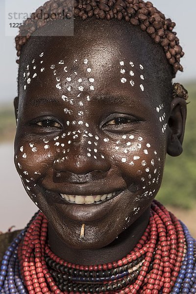 Junge Frau mit Gesichtsbemalung  Porträt  lachend  Stamm der Karo  Region der südlichen Nationen und Völker  Äthiopien  Afrika