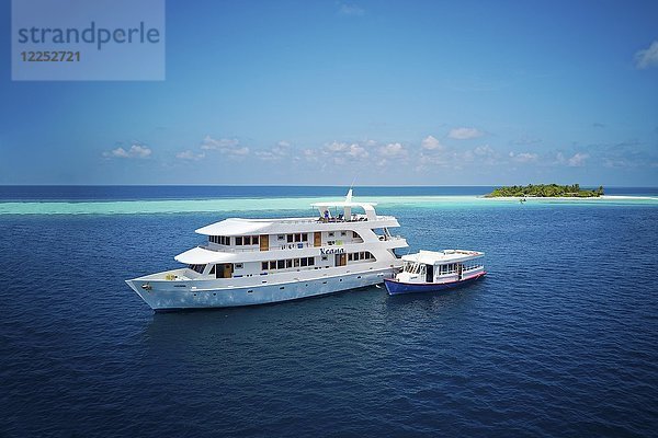 Tauchsafari-Schiff MS Keana mit Tauchdhoni vor Anker vor einer unbewohnten Palmeninsel  Ari-Atoll  Indischer Ozean  Malediven  Asien