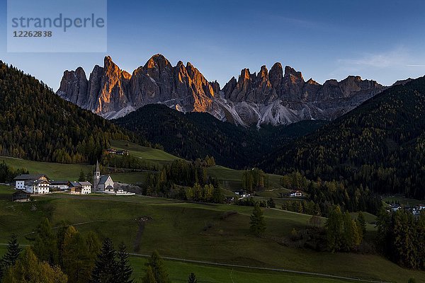 Gipfel der Geislergruppe mit Dorf St. Magdalena im Herbst im Abendlicht  Villnößtal  St. Magdalena  Südtirol  Italien  Europa