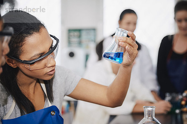 Junge multiethnische Chemie-Studenten mischen Lösungen im Labor der Universität