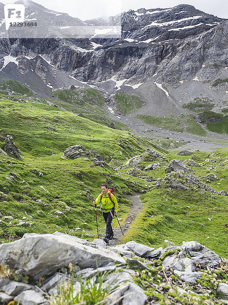 Frau beim Wandern in den Hochpyrenäen auf einem kleinen Pfad durch den Cirque de Troumouse  Frankreich