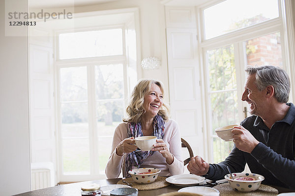 Lächelndes  glückliches reifes Paar beim Frühstück  Kaffee trinken