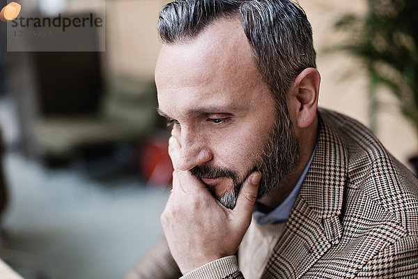 Close-up of thoughtful mature businessman at office
