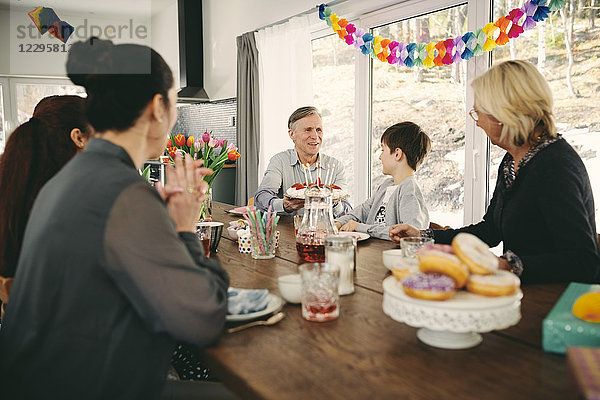 Family sitting at table during birthday party