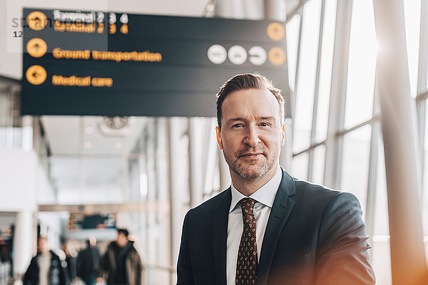 Portrait of confident mature businessman in airport terminal