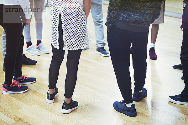 Teenage students standing in circle in dance class studio