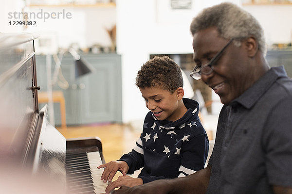 Grandfather and grandson playing piano