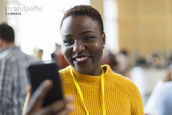Smiling businesswoman using smart phone