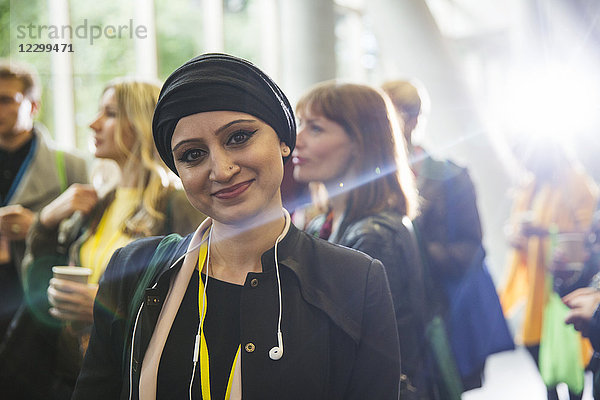 Portrait smiling woman in headscarf at conference