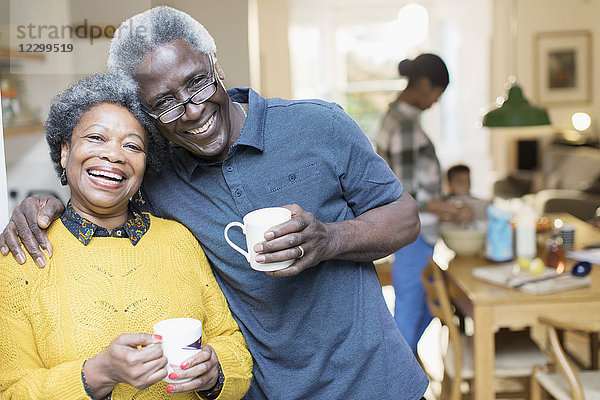 Portrait smiling  affectionate senior couple drinking coffee