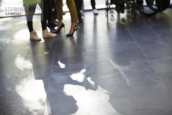 Shadow of business people on slate floor