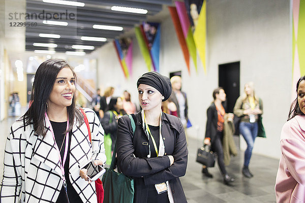 Businesswomen walking and talking at conference
