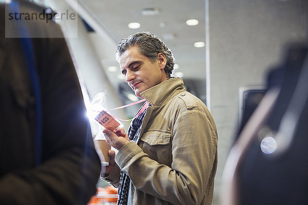 Businessman looking at conference identification pass