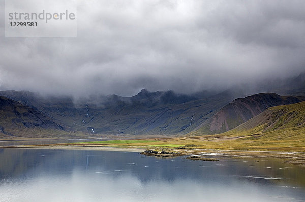 Clouds over remote landscape and water  Iceland