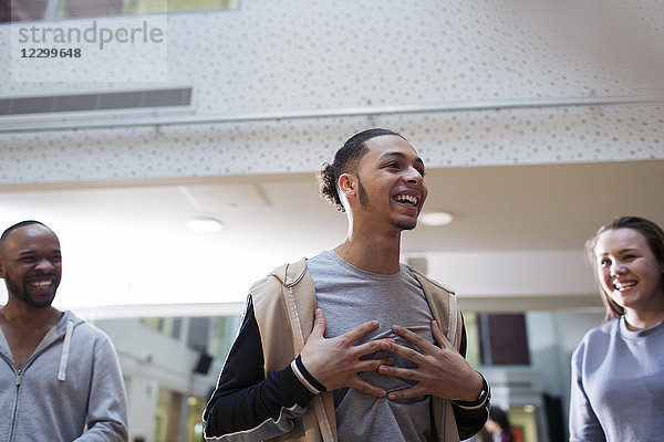 Laughing  enthusiastic teenage boy in dance class studio