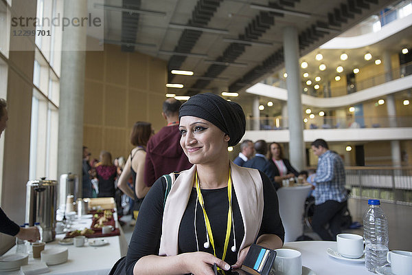 Smiling  confident businesswoman in headscarf at conference