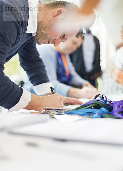 Businessman checking in at conference registration table