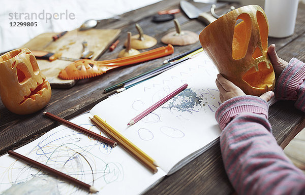 Creative girl carving Halloween pumpkins