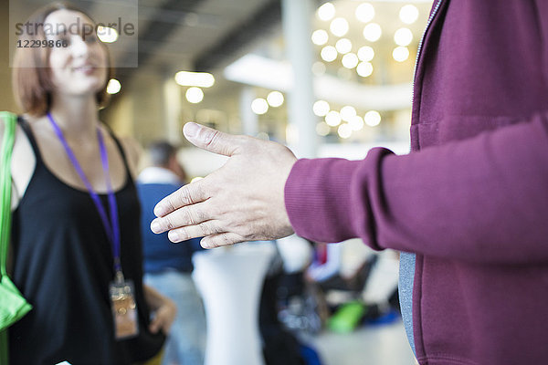 Close up businessman gesturing  talking to colleague at conference