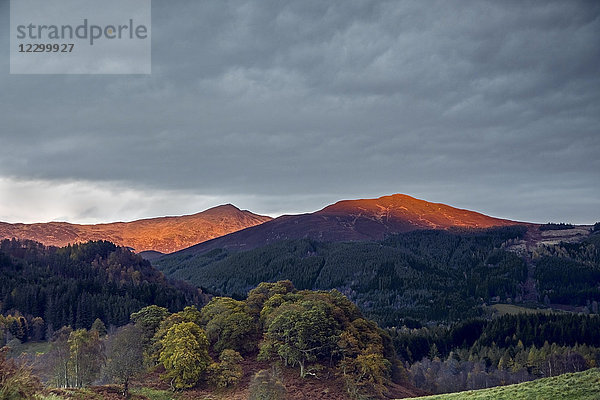 Sunlight illuminating tranquil mountaintops  Scotland