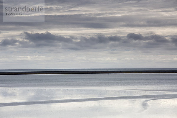 Tranquil  blue and gray clouds and ocean  Lagoon  Hofn  Iceland