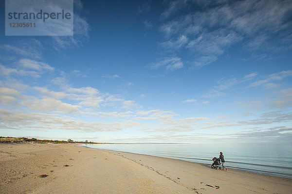 Fernaufnahme einer Mutter mit Kinderwagen am Strand von Eagle Bay  Meelup Regional Park  Westaustralien