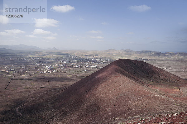 Blick vom Gipfel des Vulkans. Calderon Hondo. Wenn man den Krater des Vulkans umrundet  hat man einen spektakulären Blick auf den Norden der Insel (El Cotillo  Majanicho  Lanzarote) und die Stadt Lajares  sowie auf alle Ödlandschaften  die bei den Ausbrüchen all dieser Vulkane entstanden sind  Fuerteventura  Kanarische Inseln  Spanien