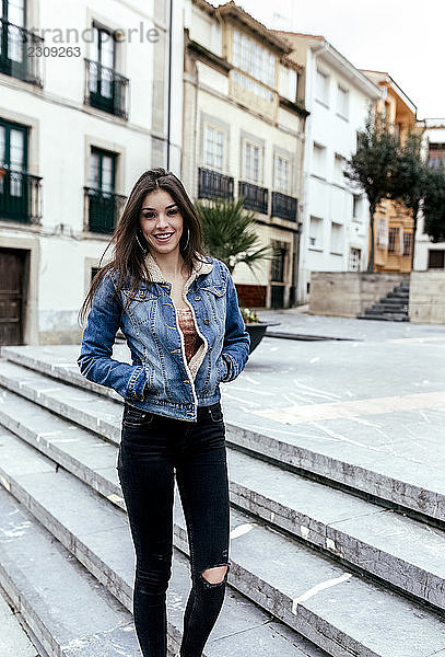 Portrait of a smiling brunette woman in a town