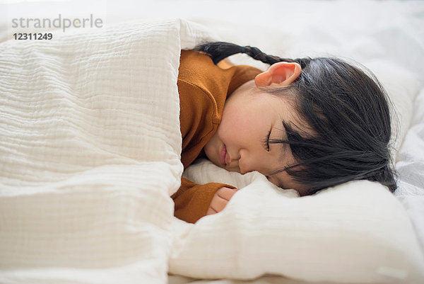 Kleines Mädchen schläft im Bett