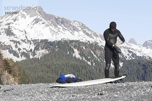 Surfer bei den Vorbereitungen zum Surfen an der Außenküste der Kenai-Halbinsel  Süd-Zentral-Alaska; Alaska  Vereinigte Staaten von Amerika