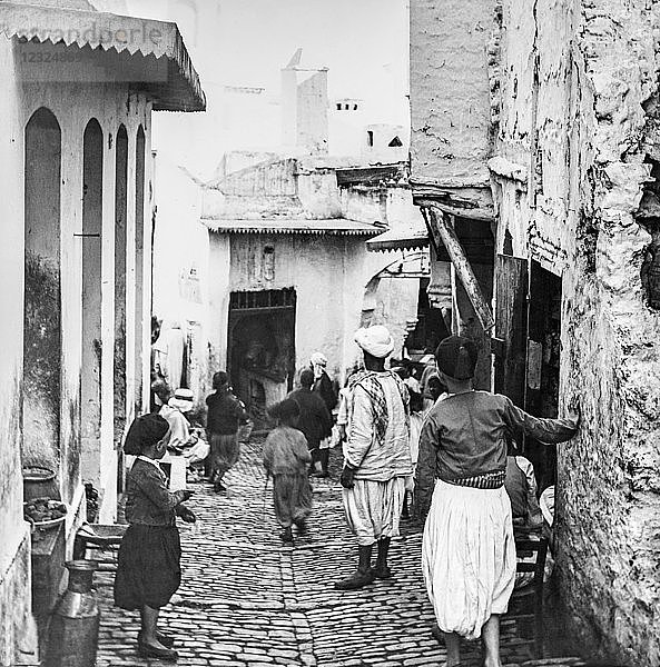 Eine enge Straße mit einem Café und Fußgängern  Laterna Magica  um 1900; Algier  Algerien