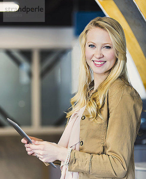 Business-Porträt einer hübschen jungen Frau  die Technologie am Arbeitsplatz nutzt; Sherwood Park  Alberta  Kanada
