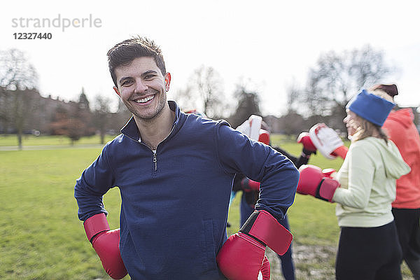 Portrait smiling  confident man boxing in park