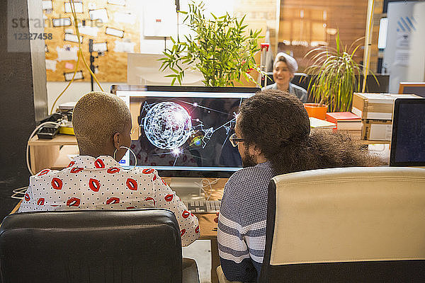 Graphic designers working at computer in office