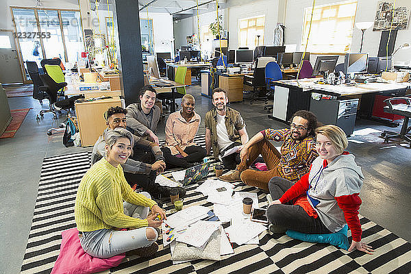 Portrait confident creative business team meeting  brainstorming in circle on office floor