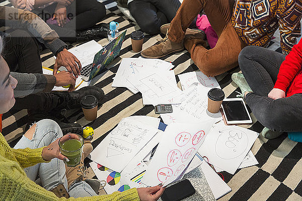 Creative business people meeting  brainstorming in circle on floor