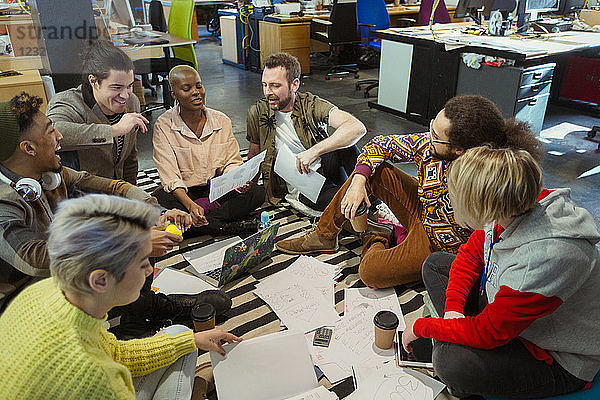 Creative business team meeting  brainstorming circle on office floor