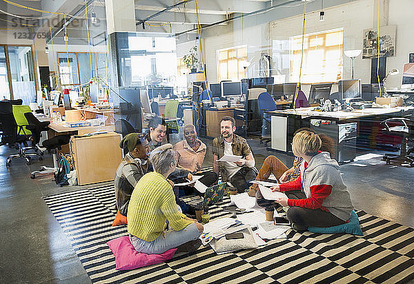 Creative business team meeting  brainstorming in circle on floor