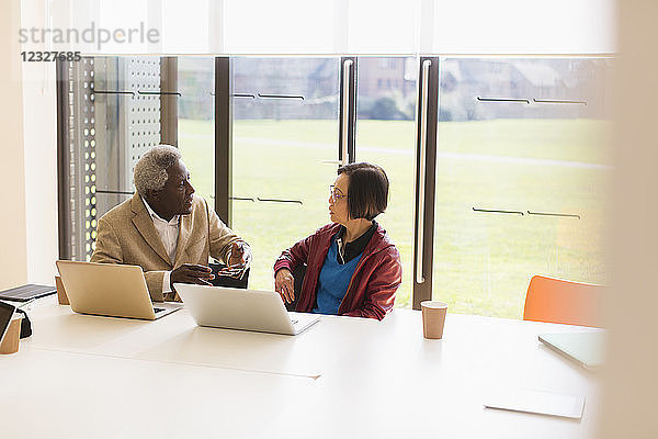 Senior business people talking in conference room meeting