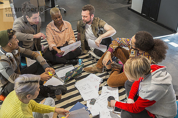 Creative business people meeting  brainstorming in circle on floor