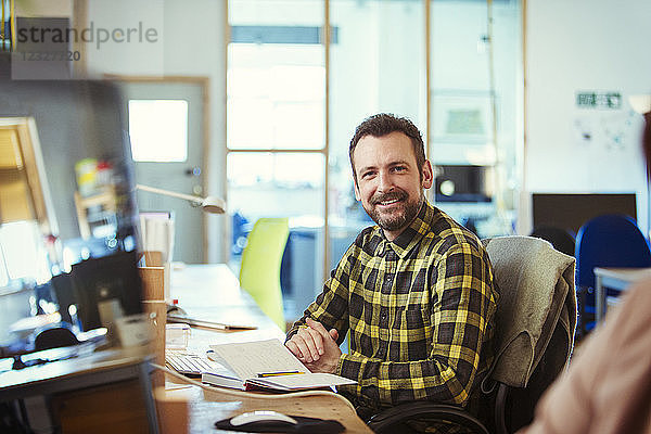 Portrait smiling  confident creative businessman working in office