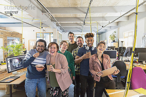 Portrait happy  playful creative business team in open plan office