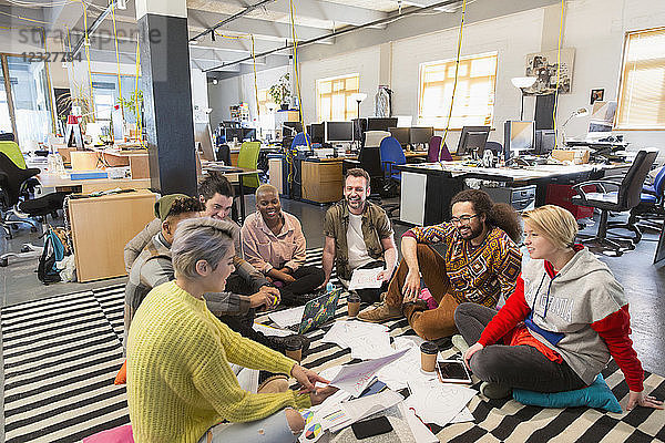 Creative business team meeting  brainstorming on floor in office