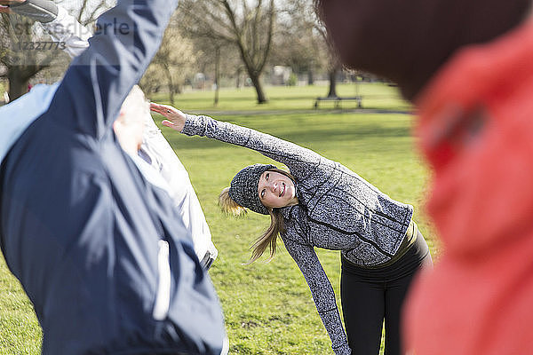 Woman exercising  stretching in park