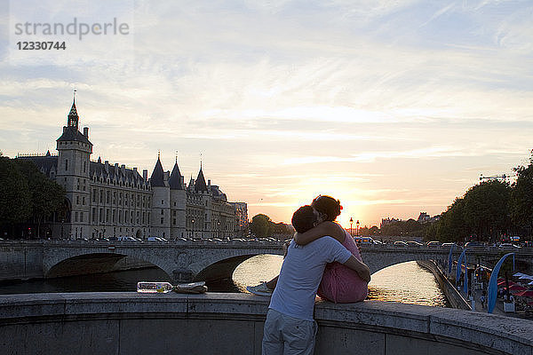 Frankreich  Paris  Liebespaar bei Sonnenuntergang. Auf der linken Seite: Die Conciergerie.