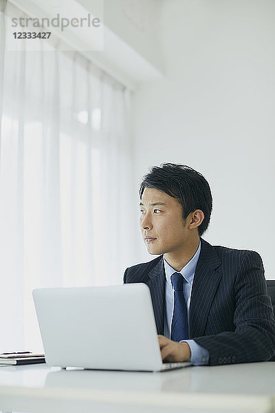 Japanischer Geschäftsmann arbeitet