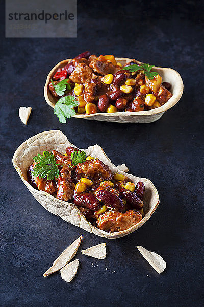 Vegetarian Chili with soy meat cut into strips in edible bowls