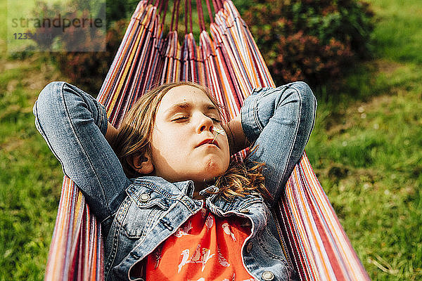 Portrait of little girl relaxing in hammock