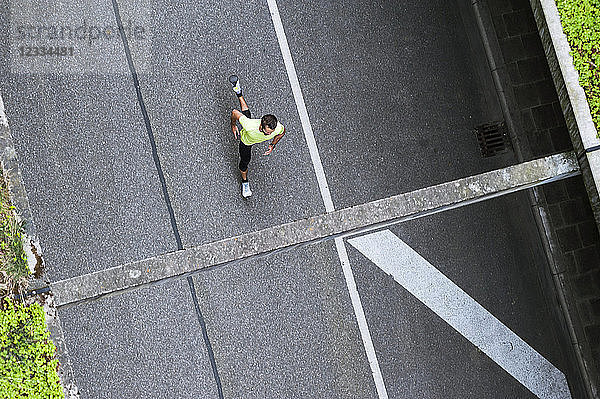Top view of man running on a street